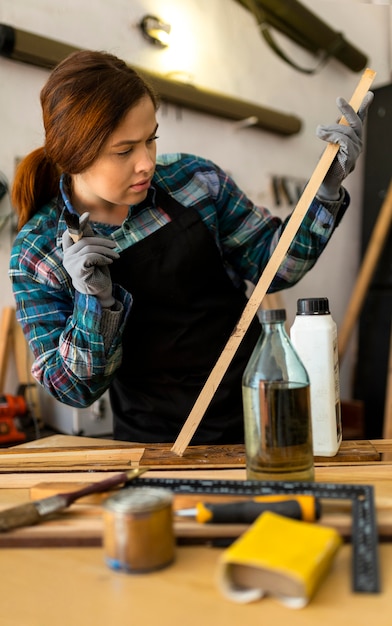 Female painting wood plank