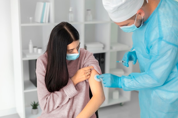 Free photo female patient getting vaccinated for coronavirus