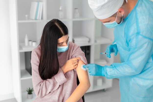 Female patient getting vaccinated for coronavirus