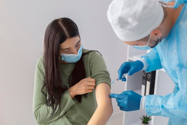Female patient getting vaccinated for coronavirus