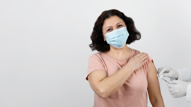 Free photo female patient getting a vaccine with copy space