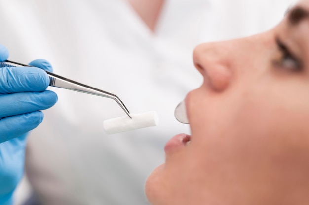 Free photo female patient having a procedure done at the dentist