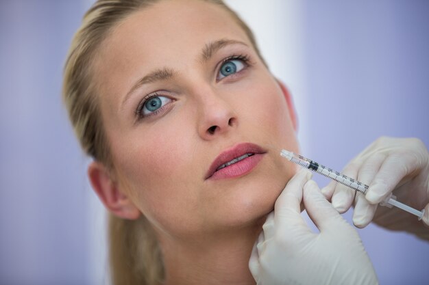 Female patient receiving a botox injection on face