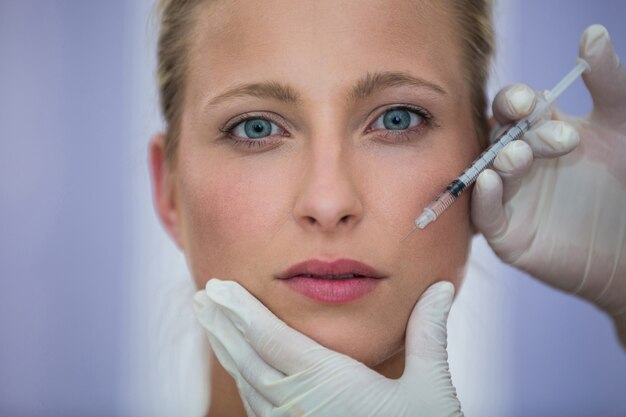 Female patient receiving a botox injection on face