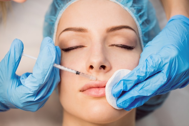 Free photo female patient receiving an injection on her face