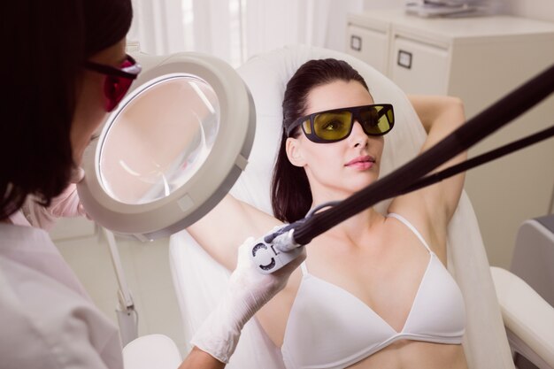 Female patient receiving laser hair removal treatment