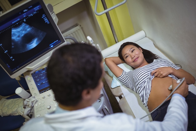 Free Photo female patient receiving a ultrasound scan on the stomach