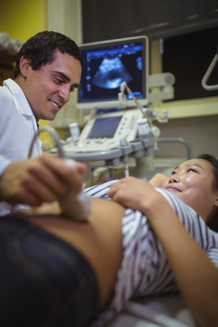 Free Photo female patient receiving a ultrasound scan on the stomach