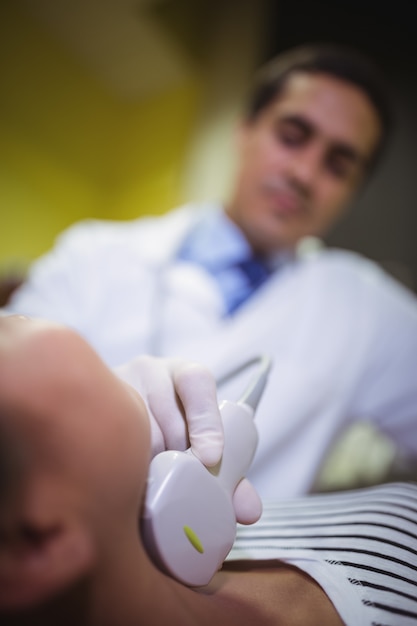 Female patient receivng a ultrasound  scan on the neck