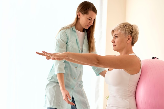 Female patient undergoing therapy with physiotherapist