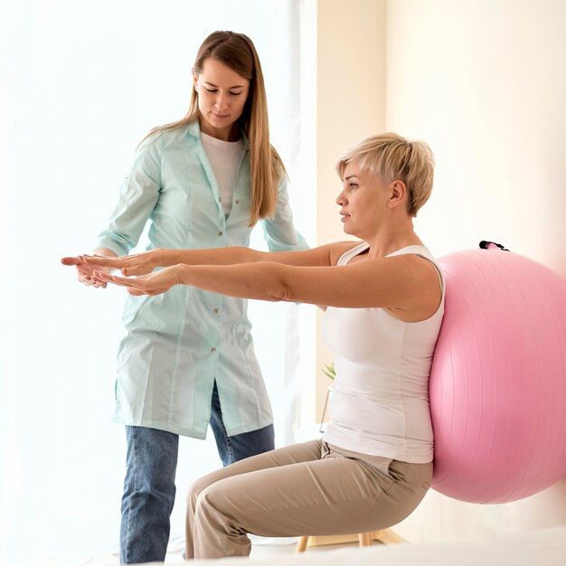 Female patient undergoing therapy with physiotherapist