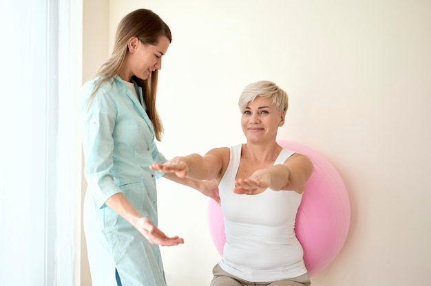 Female patient undergoing therapy with physiotherapist