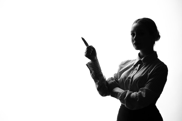 Female person silhouette posing with finger up shadow back lit young