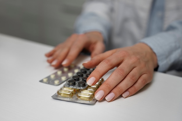 Female pharmacist with pills and medicine