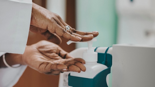 Female physician disinfecting her hands