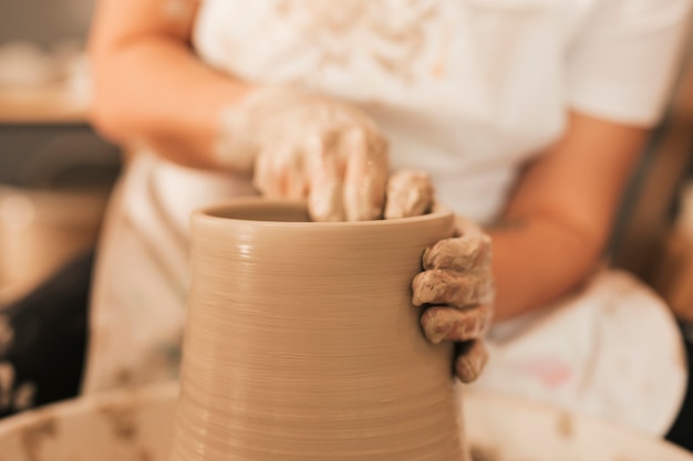 Female potter working on pottery wheel