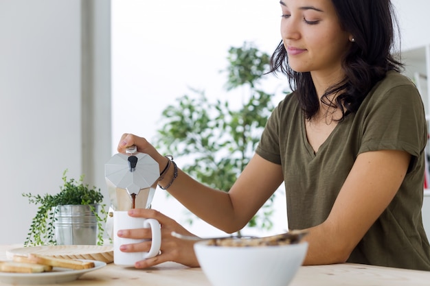 Female pouring coffee in morning