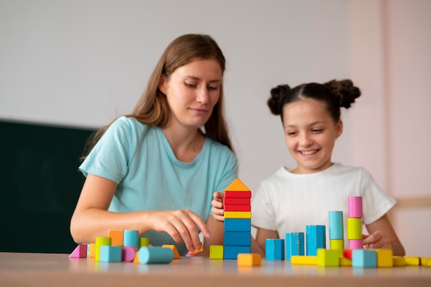 Female psychologist helping a girl in speech therapy Premium Photo