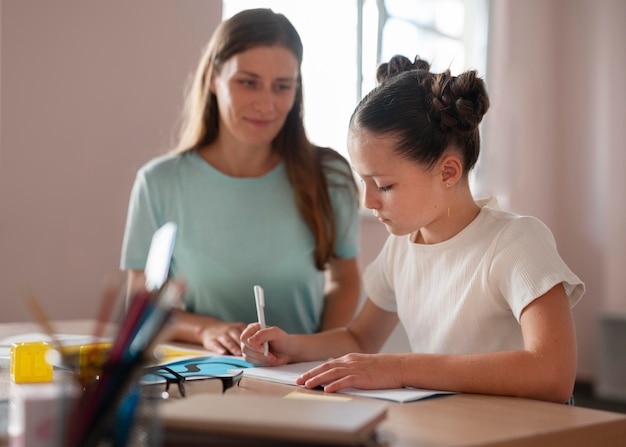 female psychologist helping a girl in speech therapy