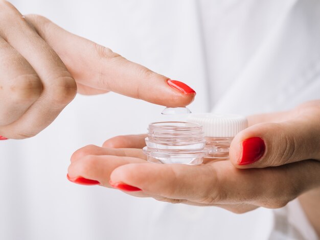 Female pulling out contact lenses from the box