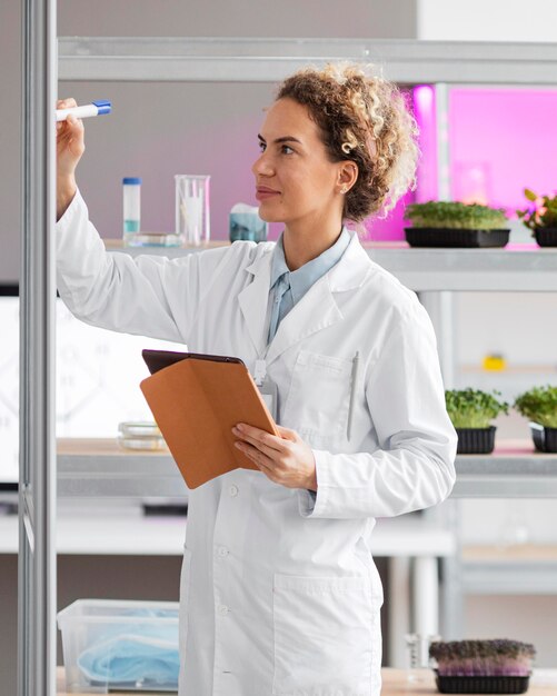 Female researcher in the biotechnology laboratory with tablet