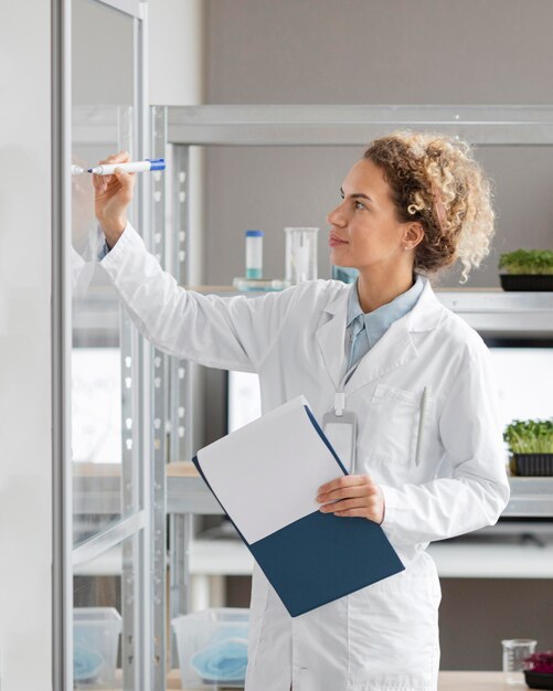 Female researcher with clipboard in the biotechnology laboratory