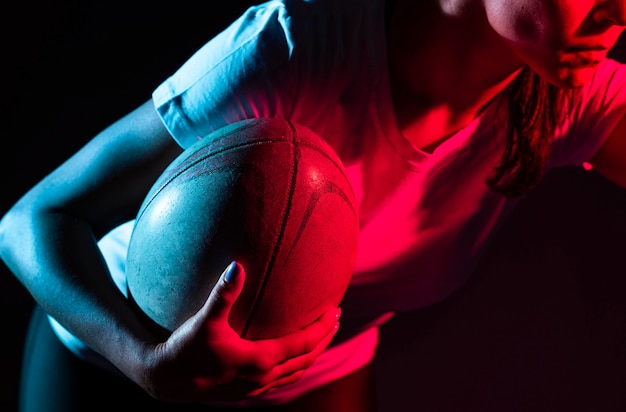 Female rugby player holding ball