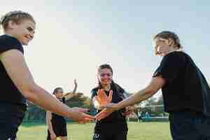 Foto gratuita giocatori di rugby femminile che uniscono le mani