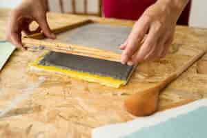 Free photo female's hand placing mold over paper pulp