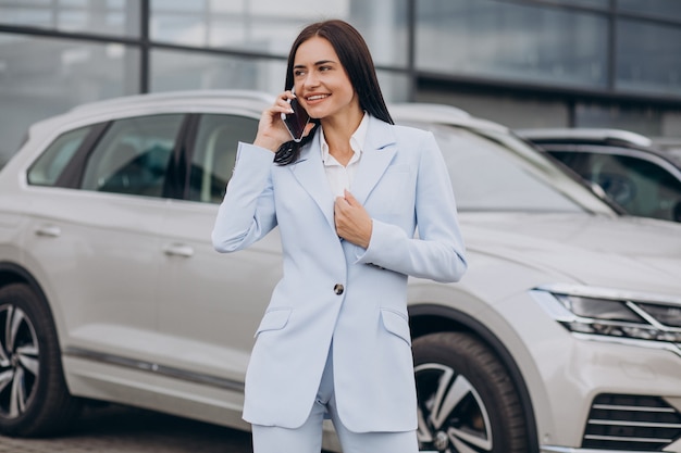 Female salesperson in a car showroom