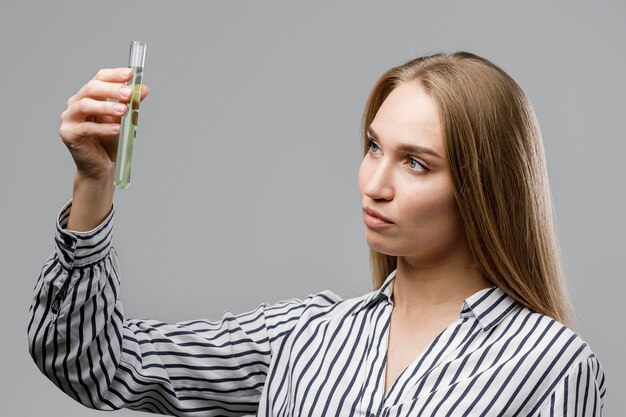 Female scientist holding test tube