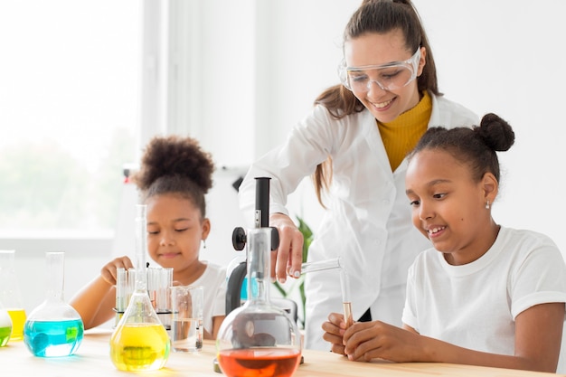 Female scientist teaching young girls about science