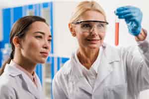 Free photo female scientists analyzing substance in the lab