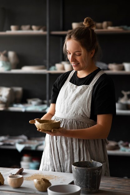 Female sculptor working with clay in the studio