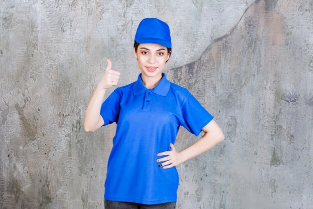 Female service agent in blue uniform showing positive hand sign