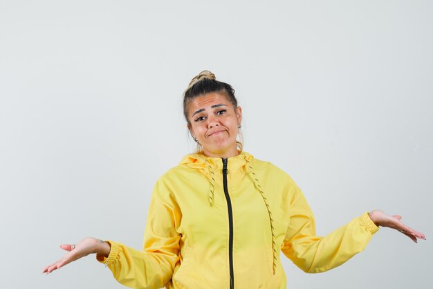 Female showing helpless gesture in sport suit and looking confused. front view.