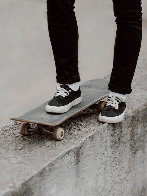 Female skater practicing skateboarding outdoors