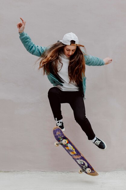 female skater practicing skateboarding outdoors