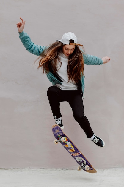 Female skater practicing skateboarding outdoors