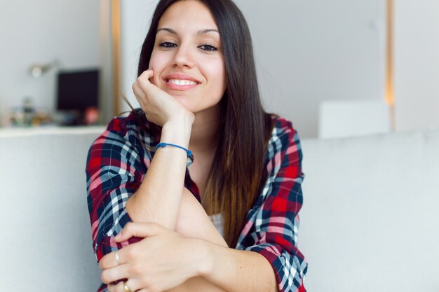 Female smiling while sitting on sofa