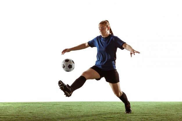 Female soccer, football player kicking ball, training in action and motion isolated on white background