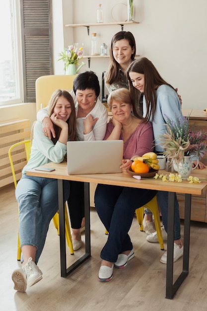 Female social club smiling at a laptop