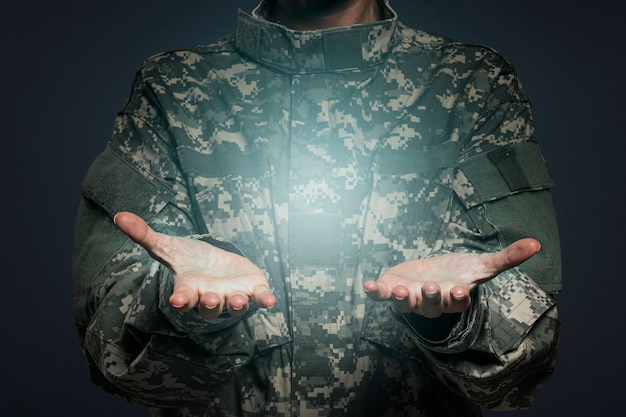 Female soldier presenting invisible object