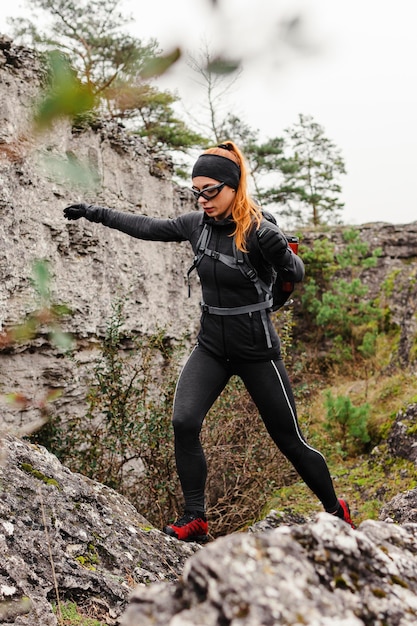 Female sporty jogger walking on stones