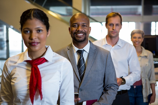 female staff and passengers standing in the airport terminal