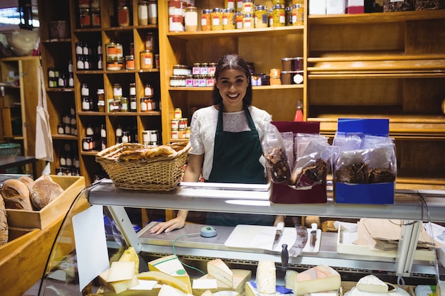 Female staff standing at cheese counter