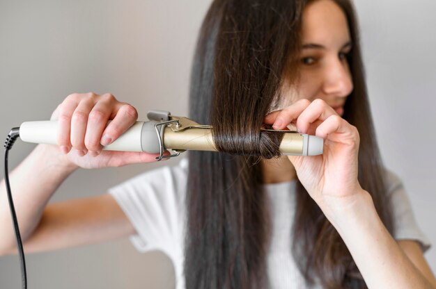 Female straightening her hair