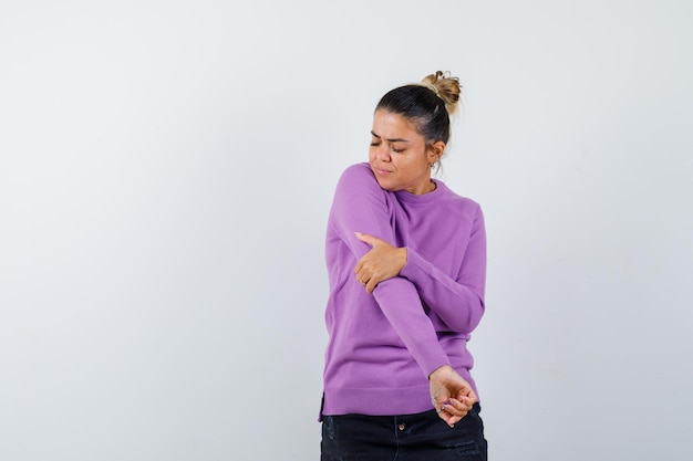 Female stretching arms in wool blouse and looking confident 