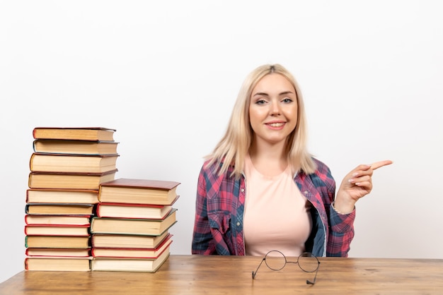 female student just sitting with books on light white