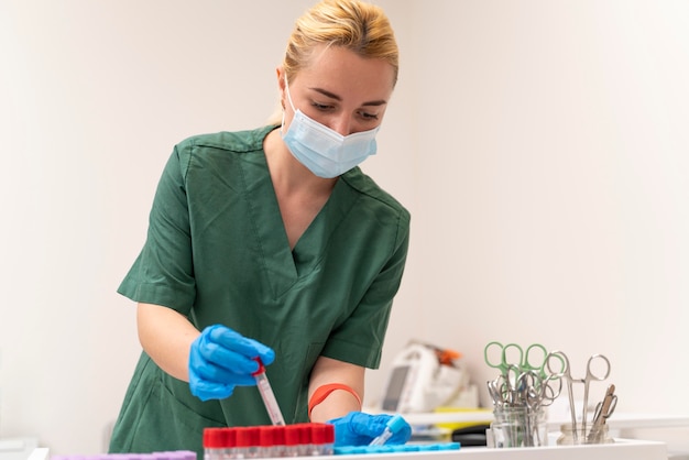 Female student at medicine wearing medical mask while doing her practice